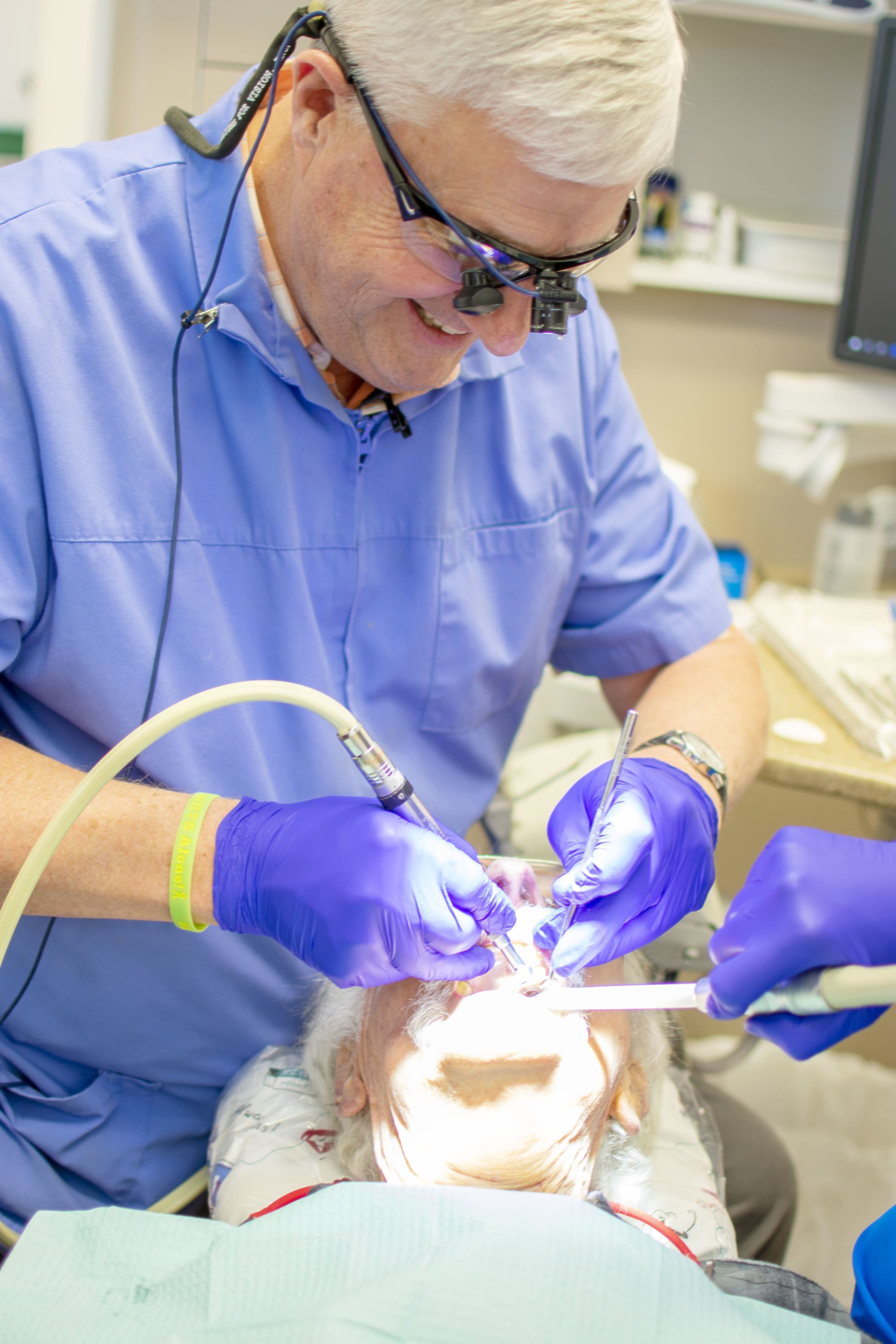 Dr. Hughes cleaning a patients smile