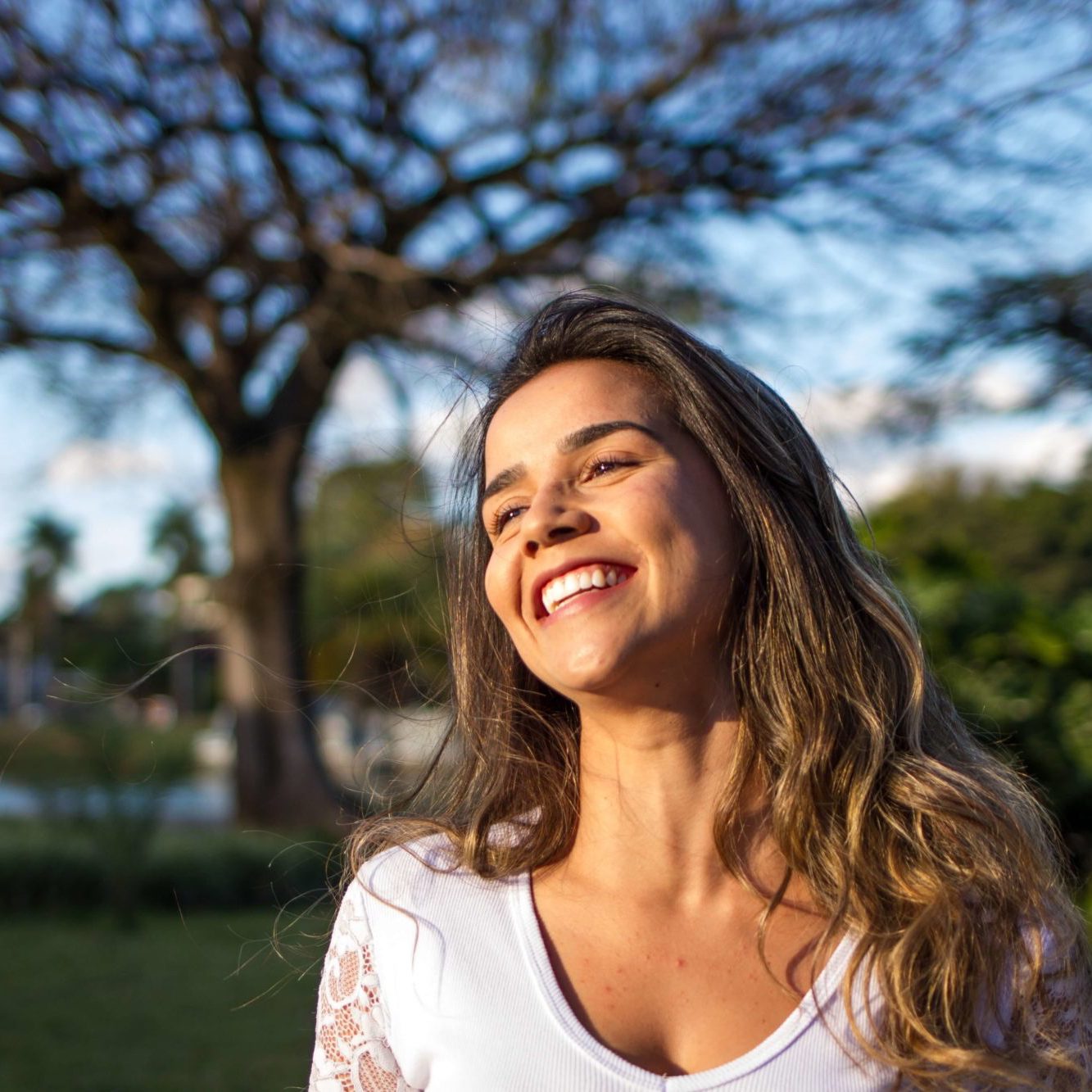 Woman smiling after a visit with Hughes Dental